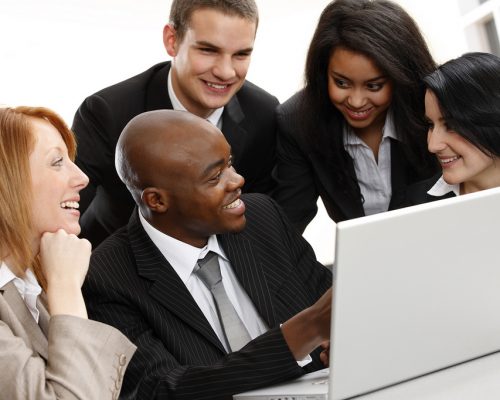 multiracial business team looking at a laptop